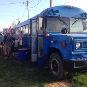 Guests grabbing some refreshments sold out of a big blue bus.